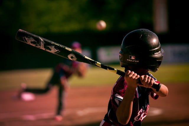 Young boy playing baseball beginner player